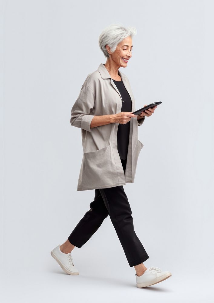 A senior woman with mobile phone walking person adult. AI generated Image by rawpixel.