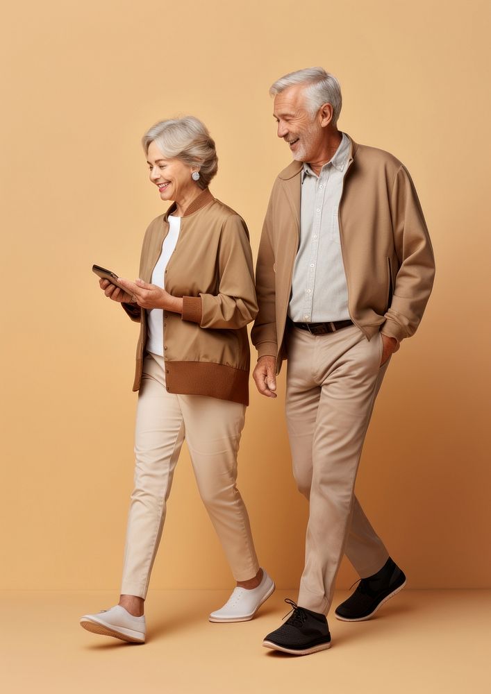 A senior couple with mobile phone walking person adult. AI generated Image by rawpixel.