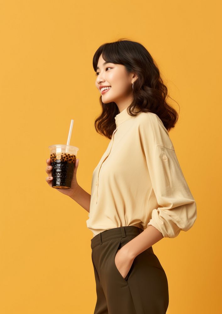 An Asian woman drinking boba tea sleeve adult cup. AI generated Image by rawpixel.