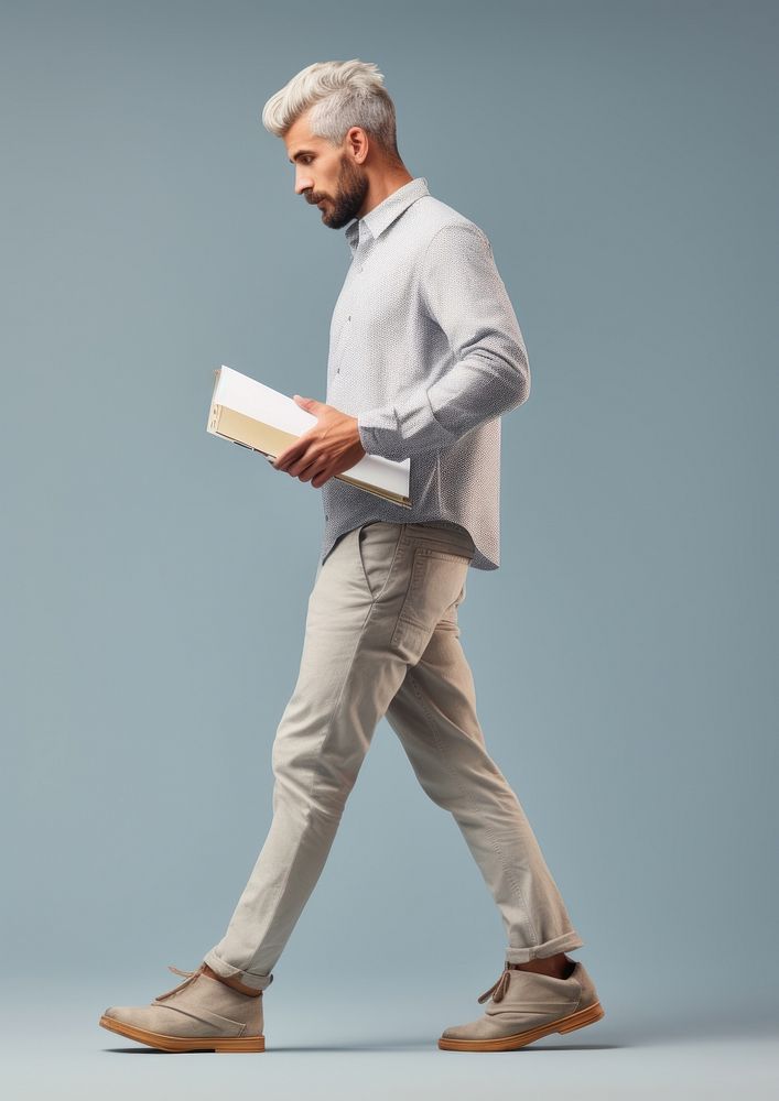 An engineer holding paper walking standing footwear. AI generated Image by rawpixel.