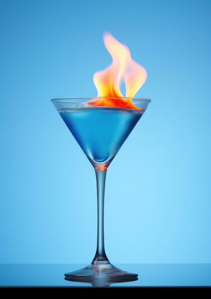 Photography food of a Burning fruity blue cocktail martini burning drink.