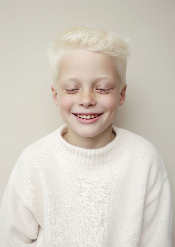 A happy albino kid wear cream sweater laughing portrait smile.