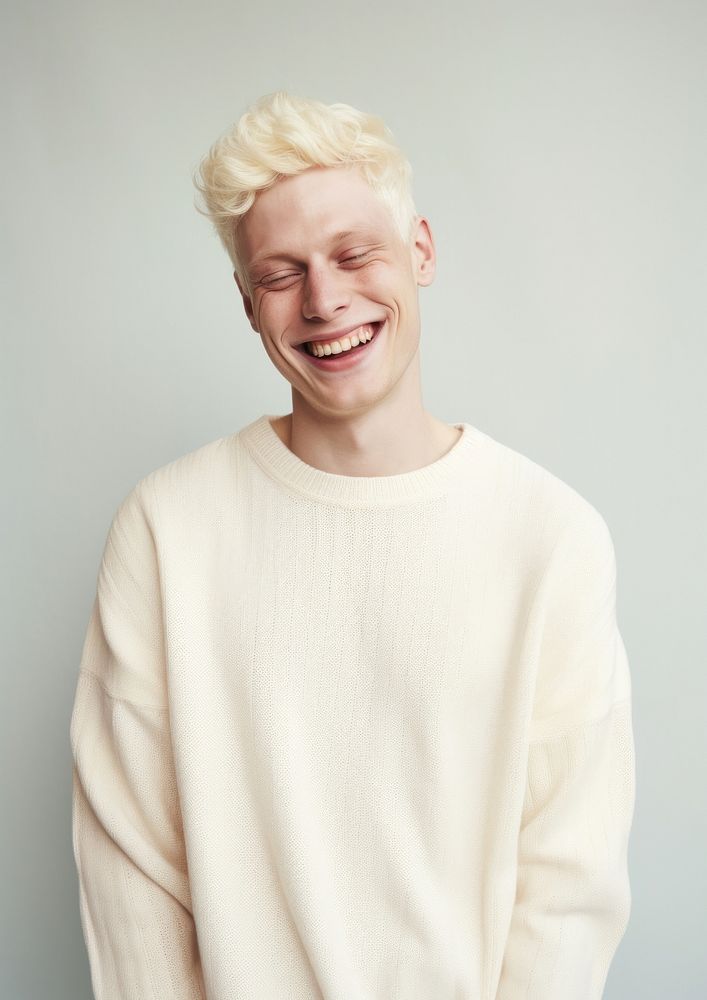 A happy albino man wear cream sweater laughing smile happiness.