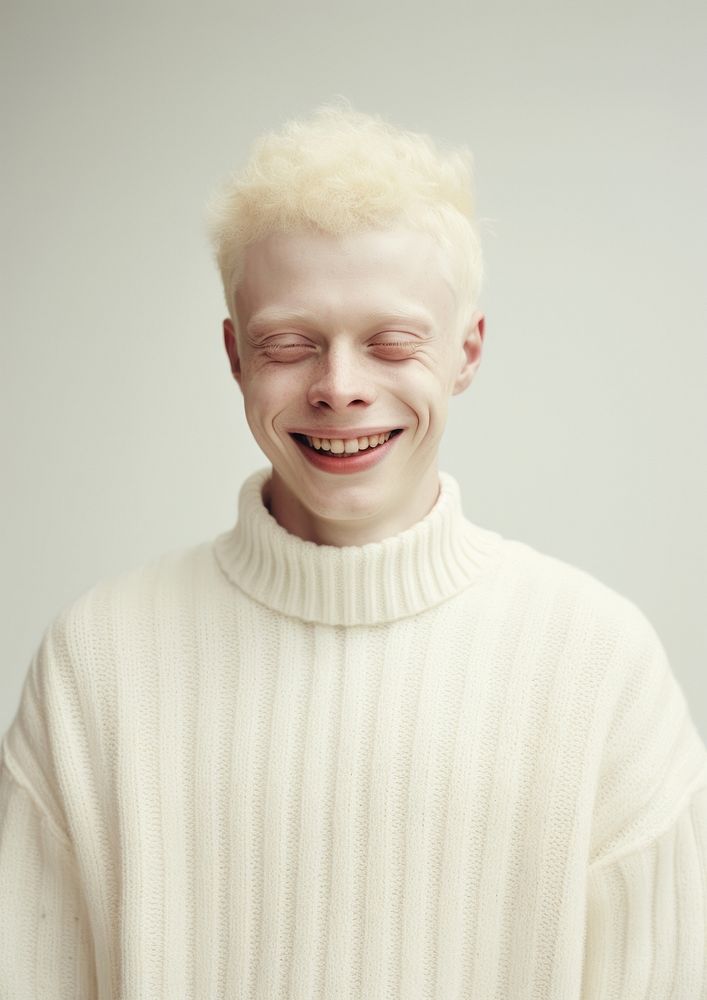 A happy albino man wear cream sweater portrait smile photo.