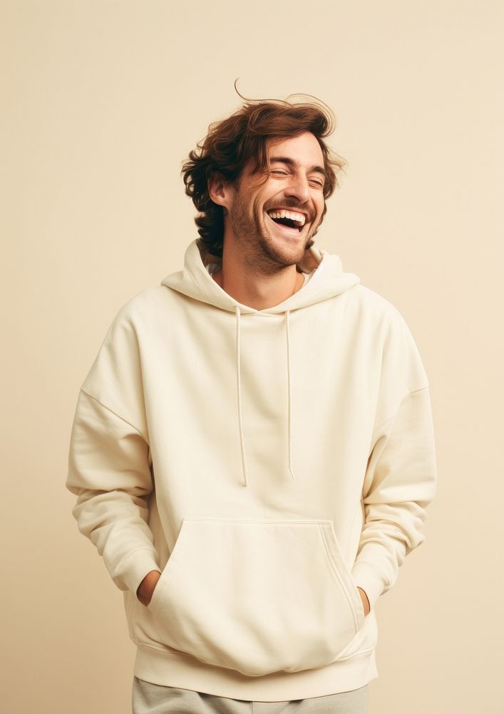 A happy british man wear cream hoodie sweatshirt laughing fashion.