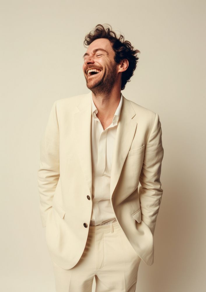 A happy british man wear cream casual suit laughing fashion blazer.