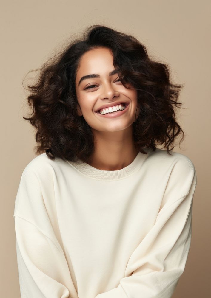 A happy hispanic woman wear cream sweater laughing fashion adult.