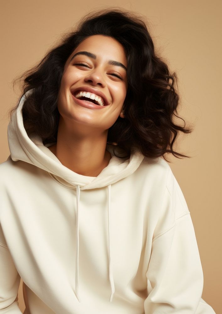 A happy hispanic woman wear cream hoodie laughing fashion smile.