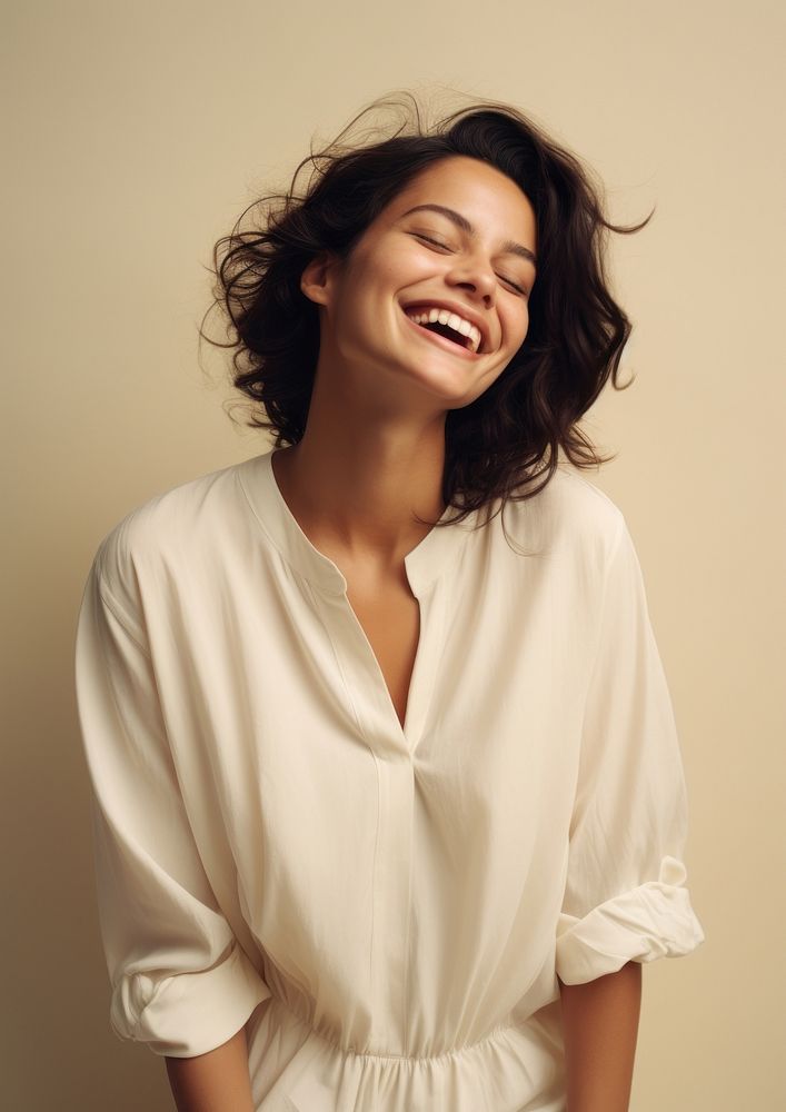 A happy hispanic woman wear cream dress laughing fashion blouse.