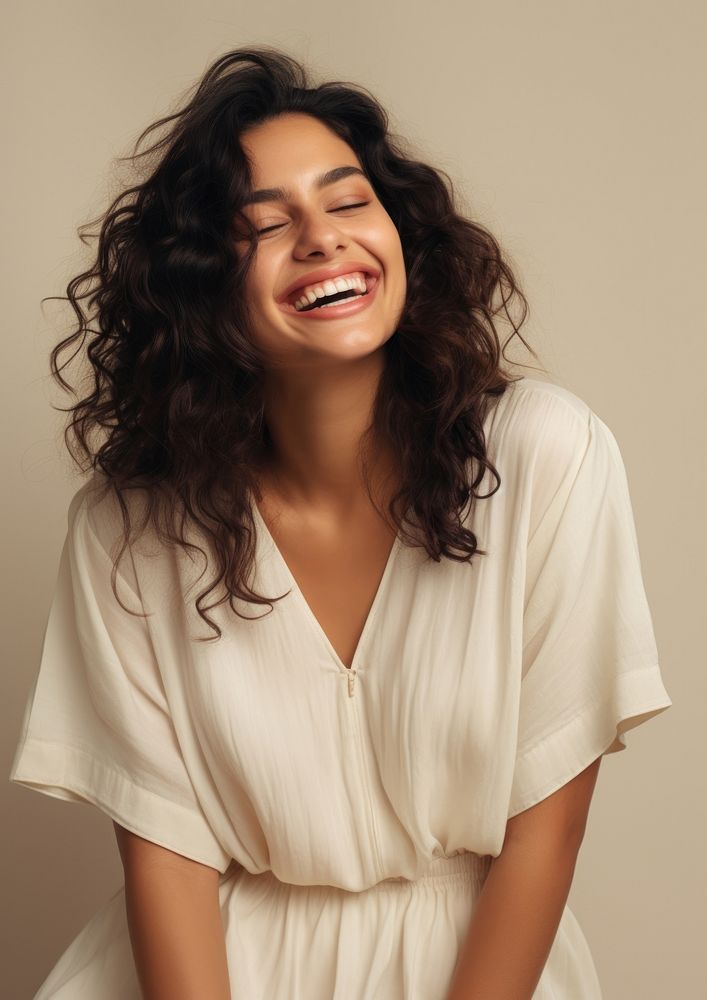 A happy hispanic woman wear cream dress laughing fashion smile.