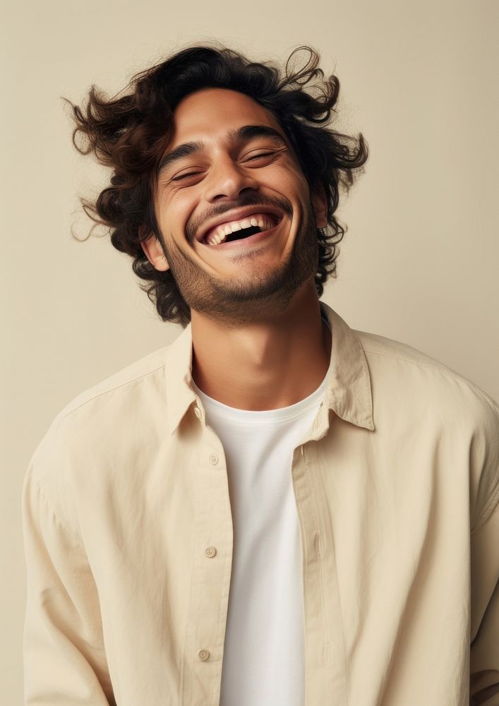 A happy hispanic man wear cream sweater laughing fashion adult.