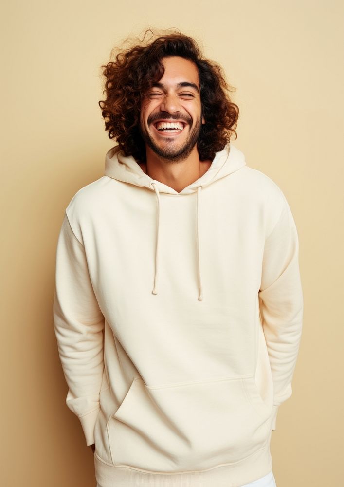 A happy hispanic man wear cream hoodie sweatshirt laughing sweater.