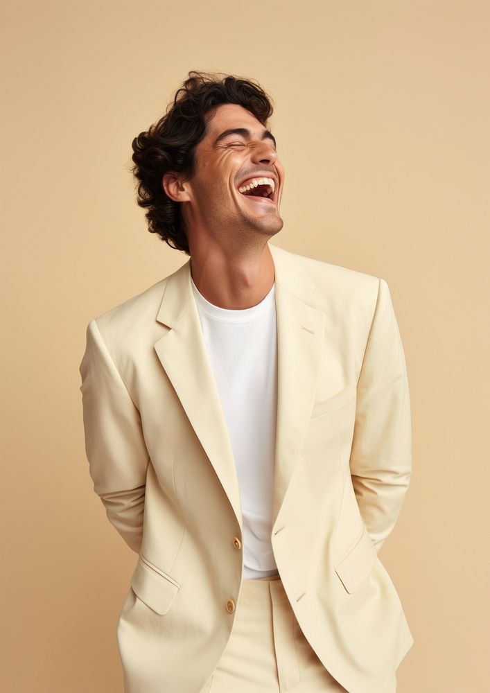 A happy hispanic man wear cream casual suit laughing fashion adult.
