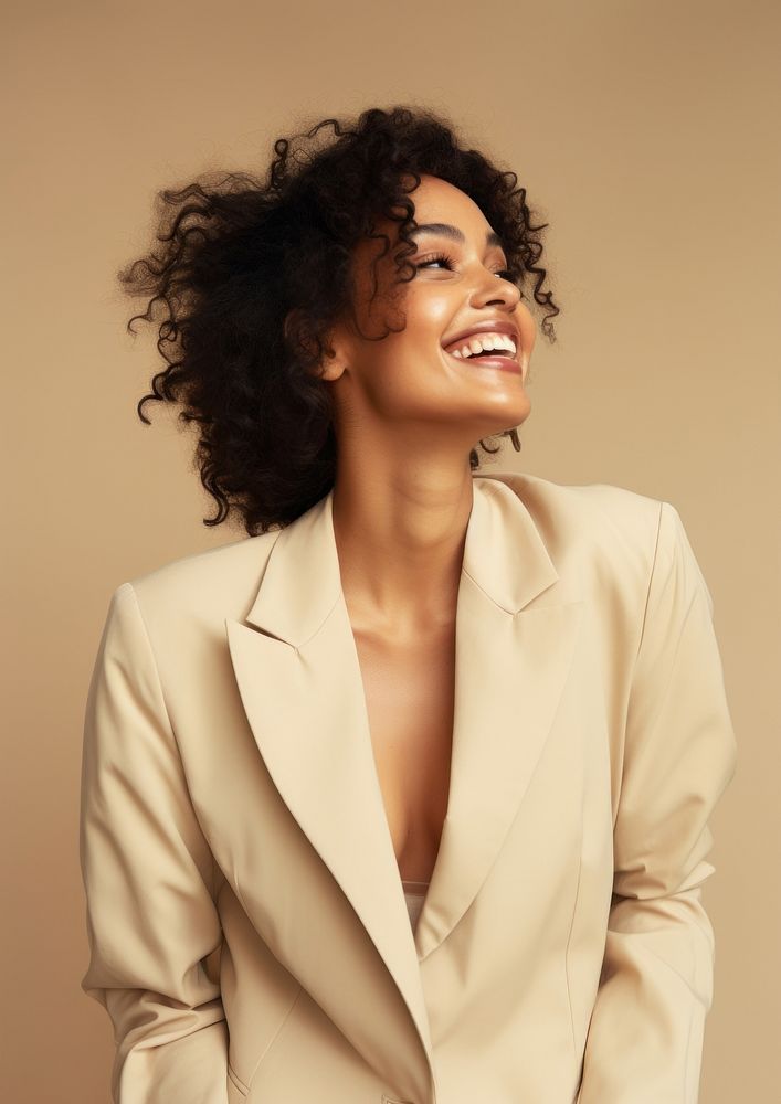 A happy mixed race african american woman wear cream casual suit portrait laughing fashion.