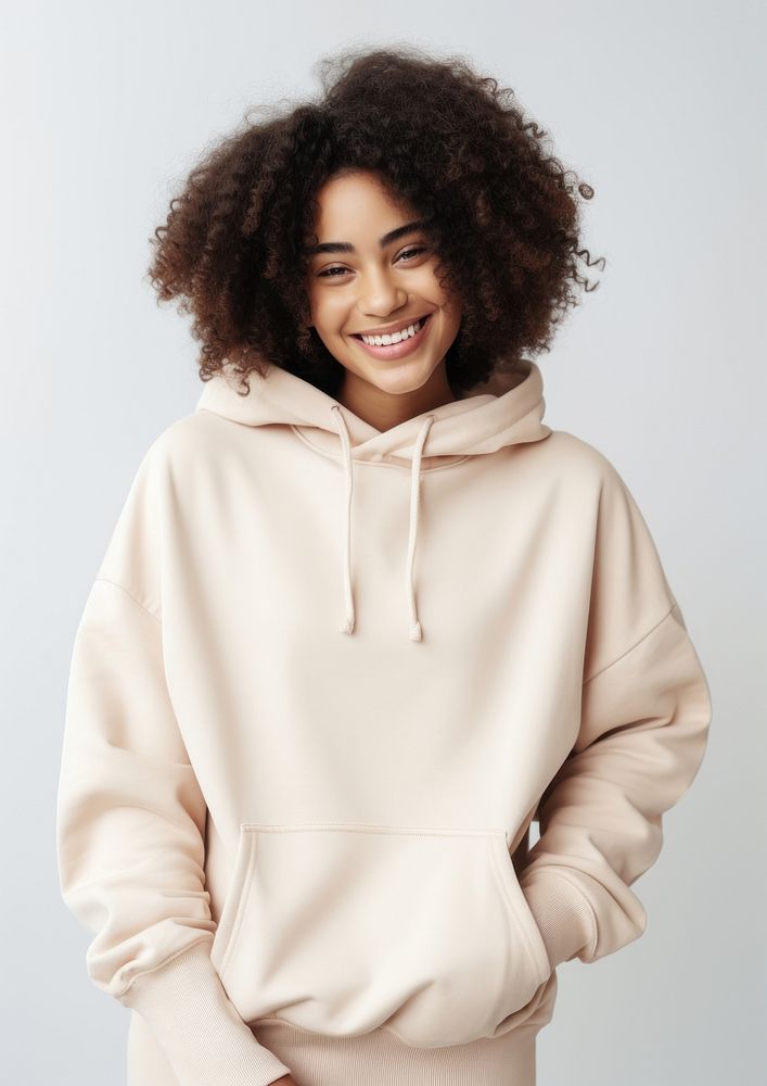 A happy mixed race african american woman wear cream hoodie sweatshirt portrait sweater.