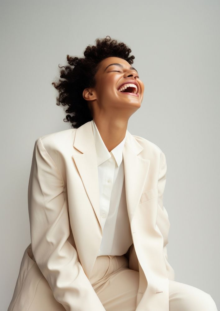 A happy mixed race african american woman wear cream casual suit laughing fashion adult.
