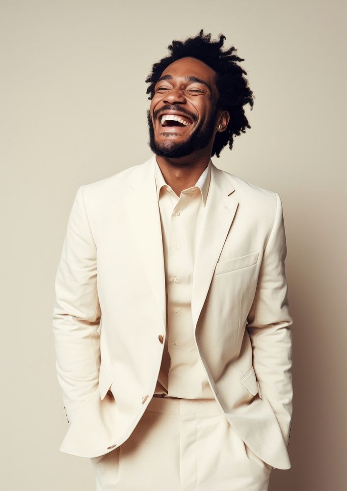 A happy mixed race african american man wear cream casual suit laughing adult smile.