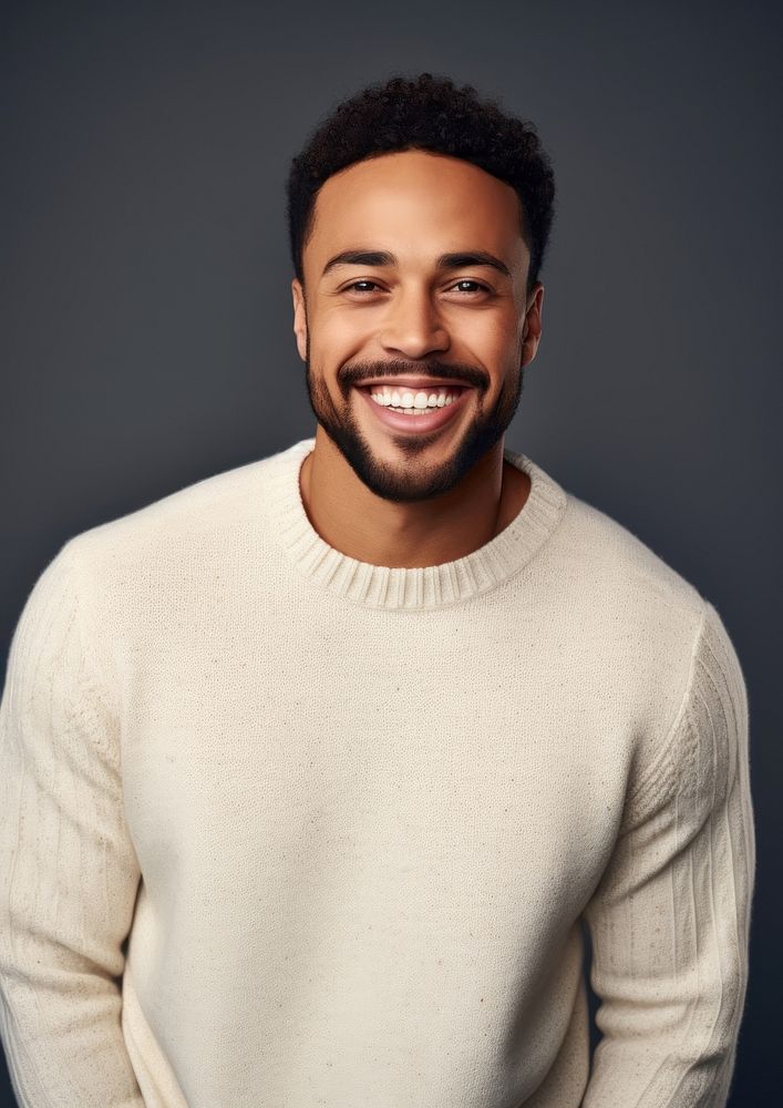 A happy mixed race british man wear cream sweater laughing adult smile.