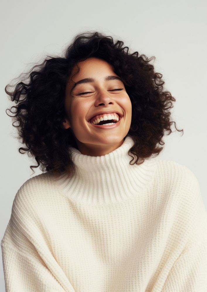A happy mixed race british woman wear cream sweater laughing smile adult.