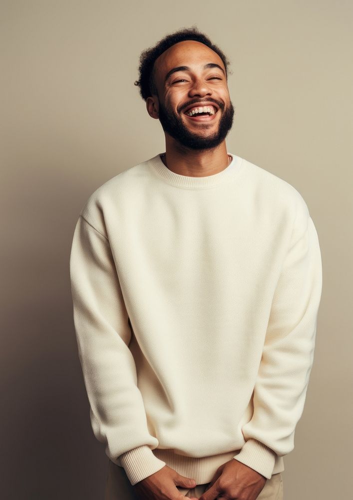 A happy mixed race british man wear cream sweater laughing smile adult.
