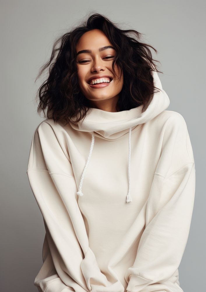 A happy mixed race japanese woman wear cream hoodie laughing fashion smile.