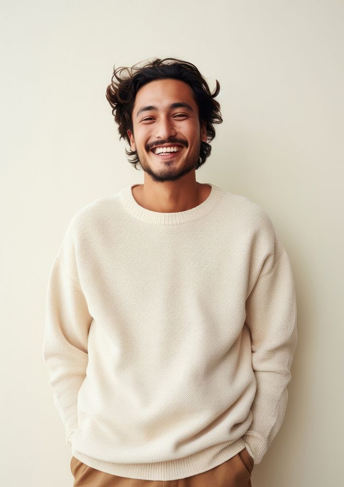 A happy mixed race japanese man wear cream sweater laughing fashion smile.