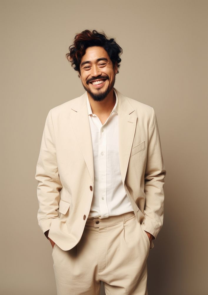 A happy mixed race japanese man wear cream casual suit laughing fashion blazer.