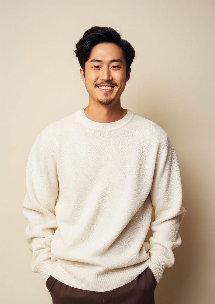 A happy mixed race korean man wear cream sweater portrait smile photo.