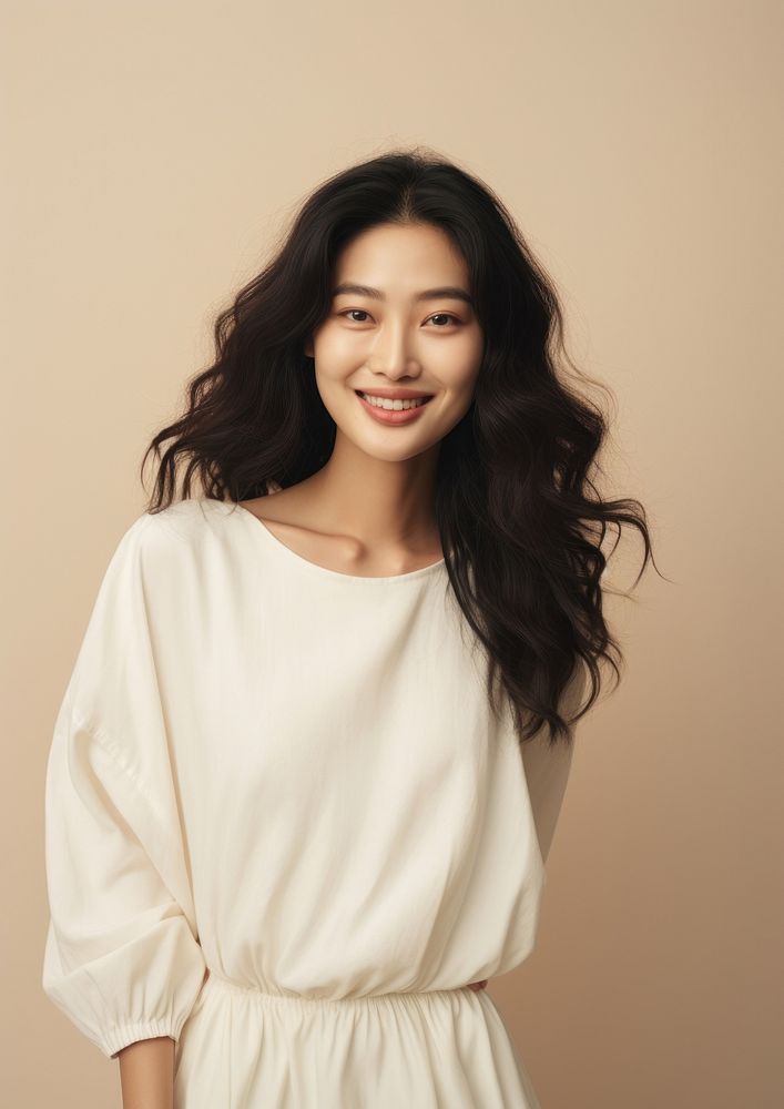A happy mixed race korean woman wear cream dress portrait fashion blouse.