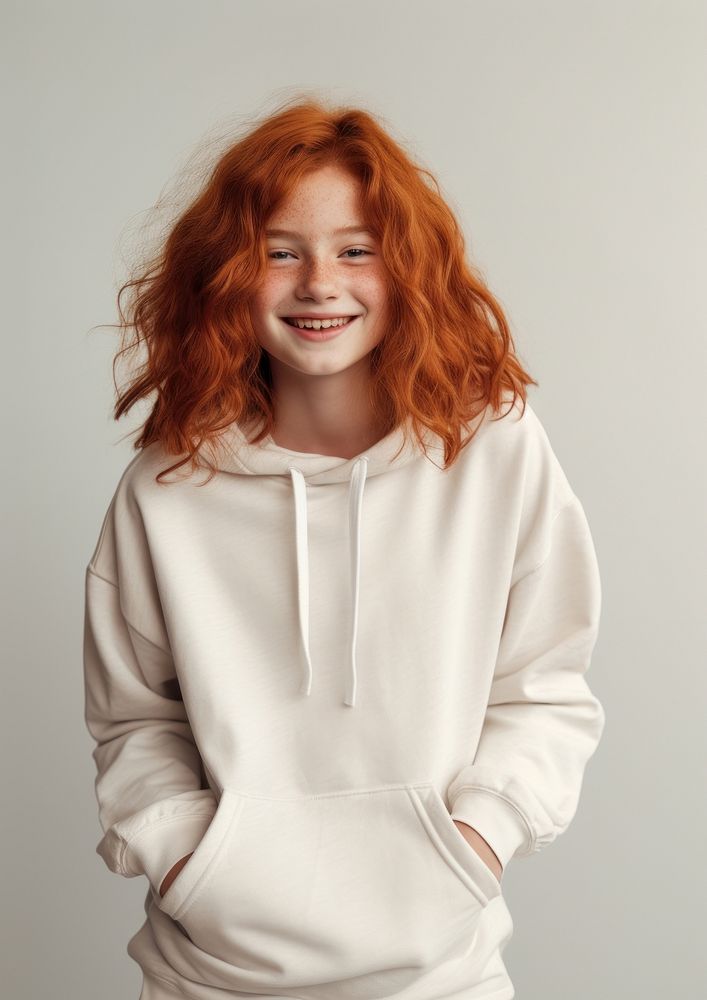 A happy red hair kid wear cream hoodie sweatshirt laughing portrait.