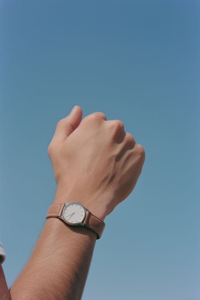A hand wearing watch wristwatch finger outdoors.
