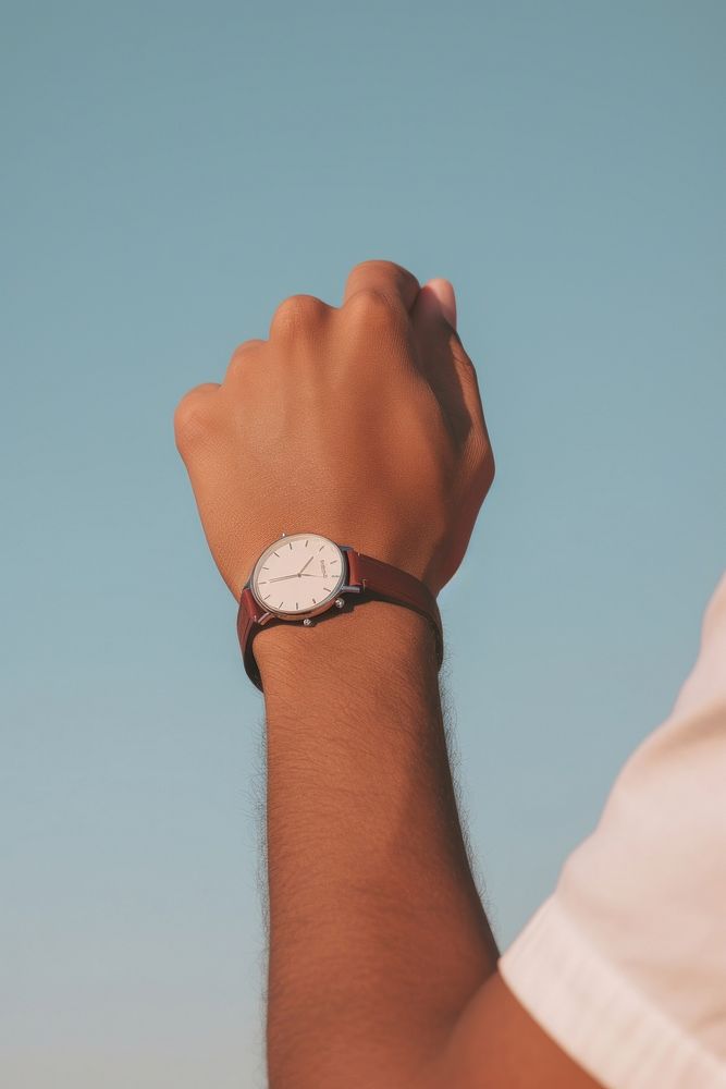 A hand wearing watch wristwatch deadline accuracy.