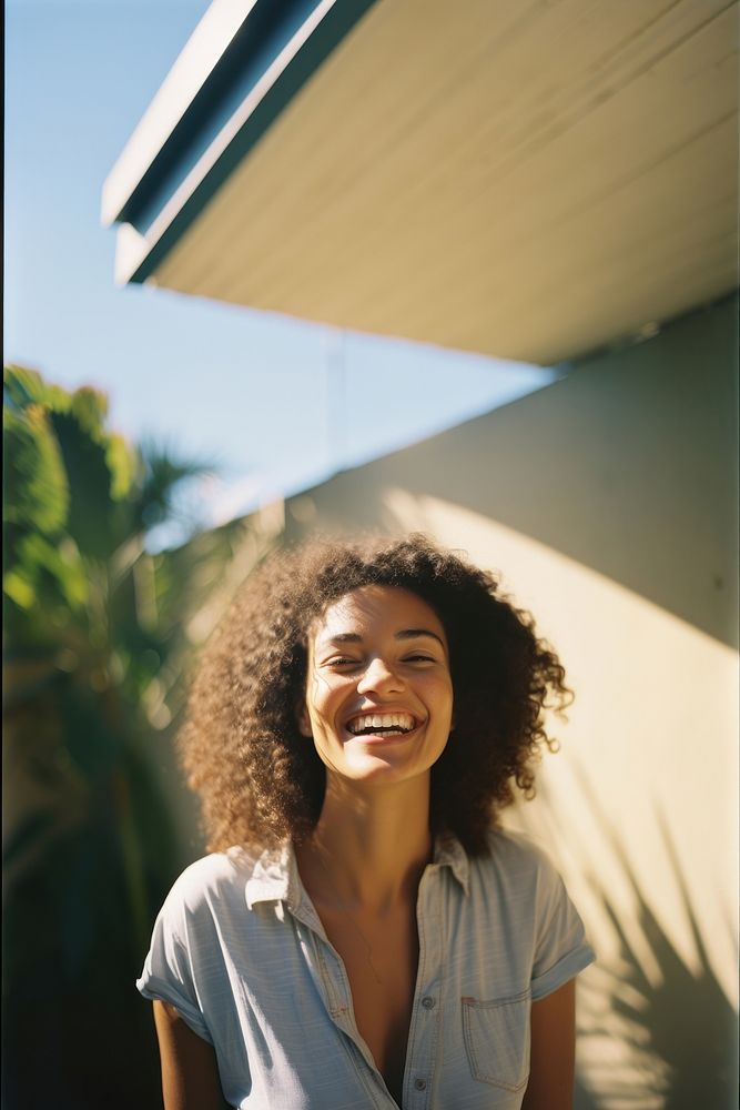 A mixed race american-african woman smiling adult smile.