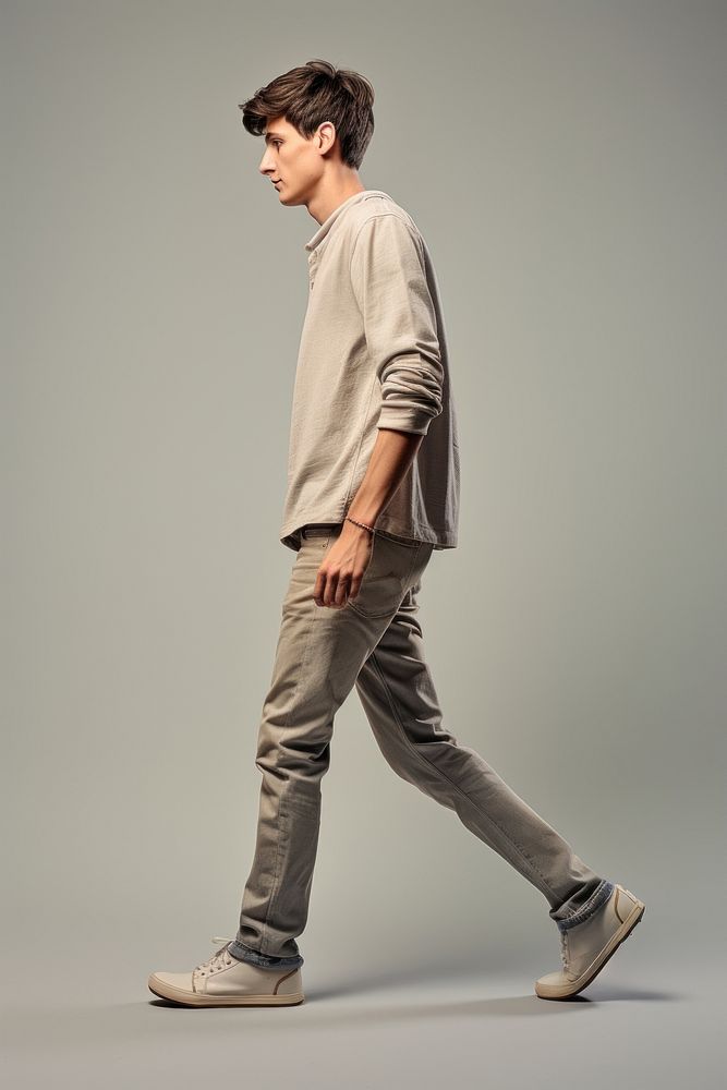 A teenager man walking in studio footwear shoe architecture.