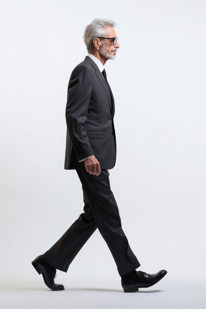 A senior man walking in studio wearing suit footwear portrait tuxedo.