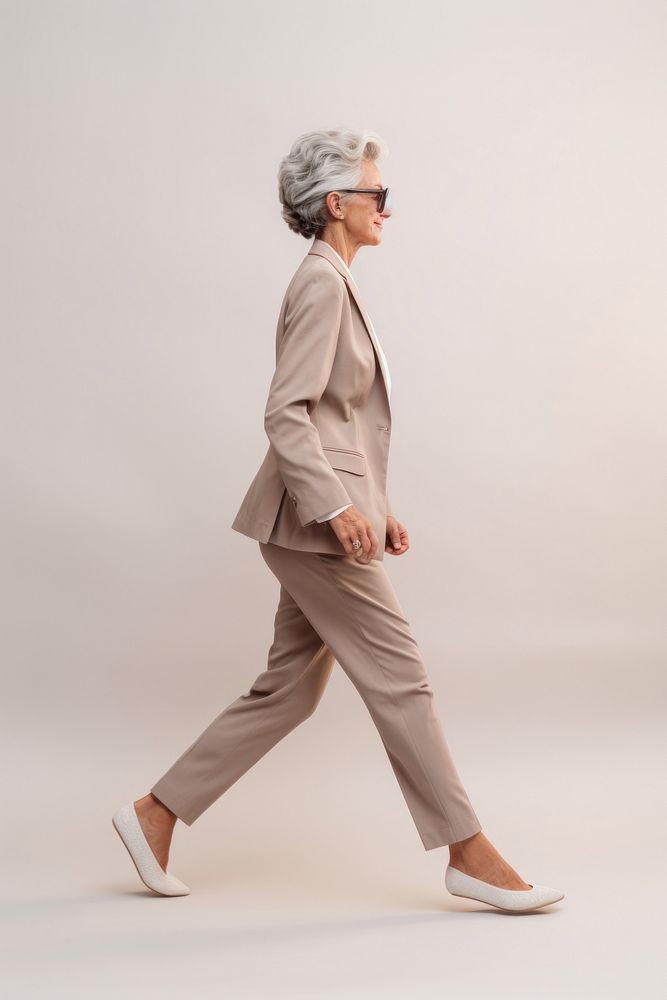 A senior woman walking in studio footwear adult shoe.