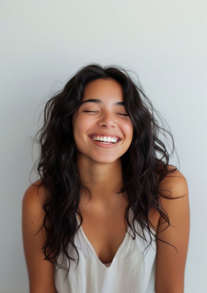 A Latina woman laughing smiling smile.