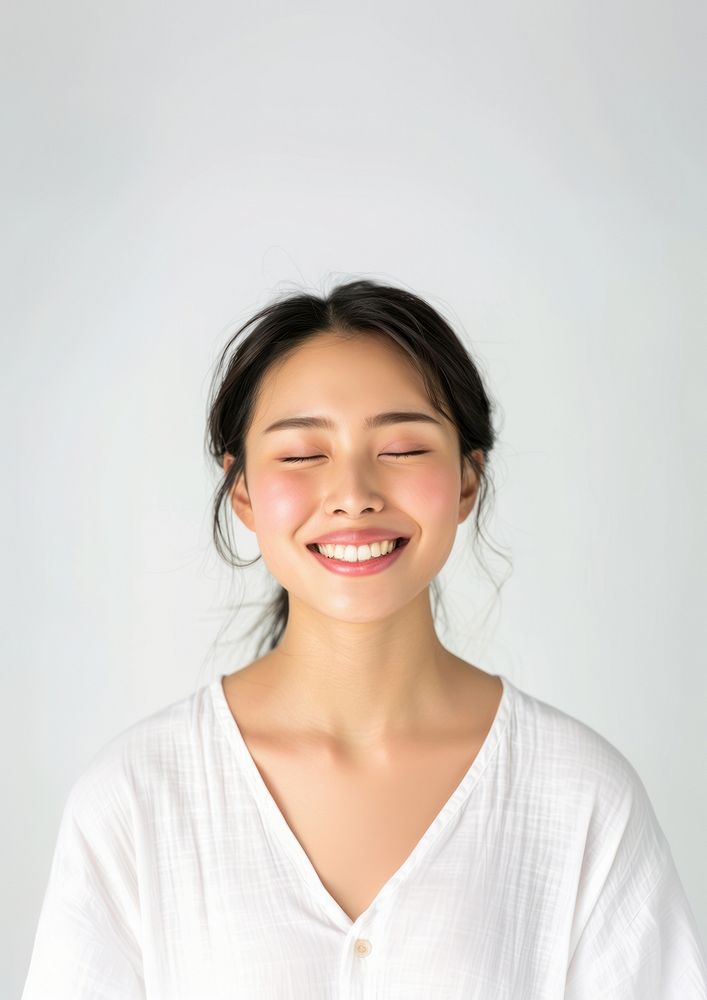 An Asian woman laughing smiling adult.