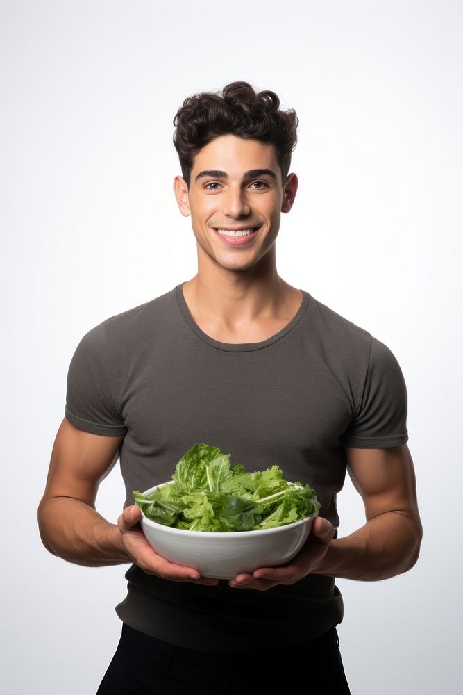 Male holding bowl vegetable portrait.