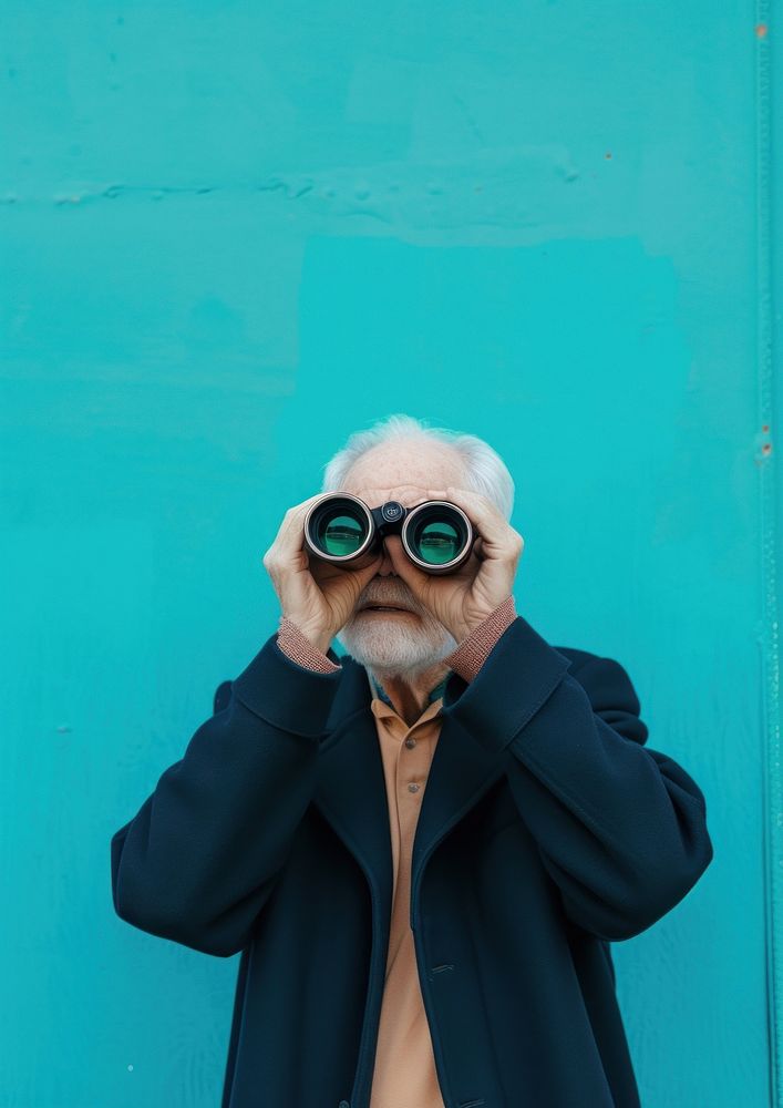 Old man using binoculars portrait adult photo.