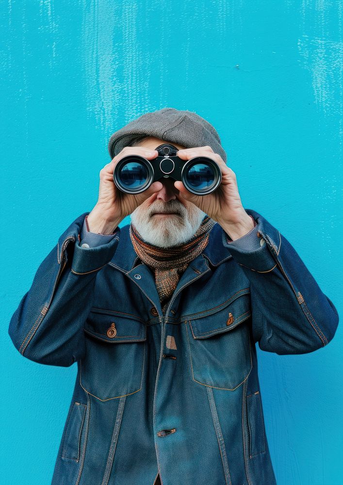 Old man using binoculars portrait photo blue.