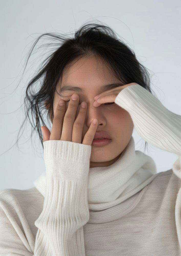 Woman with hand cover her eyes portrait worried sweater.