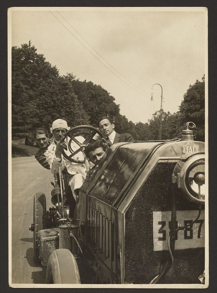 Men behind wheel of car by Fédèle Azari