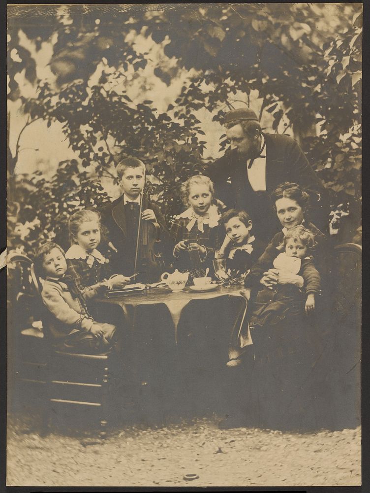 Group portrait around table by Victor Dix