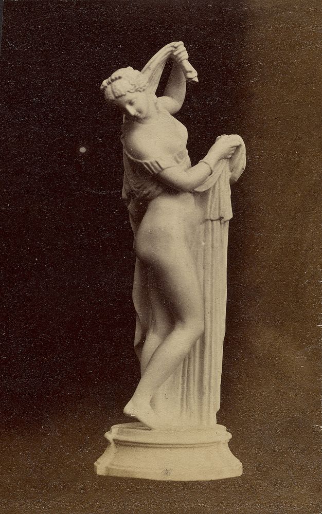 Statue of partially draped female figure