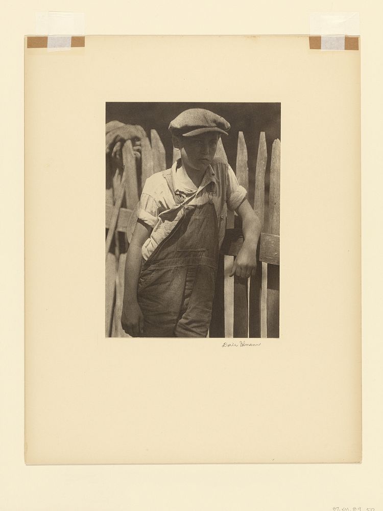 Boy Standing by Unpainted Fence by Doris Ulmann