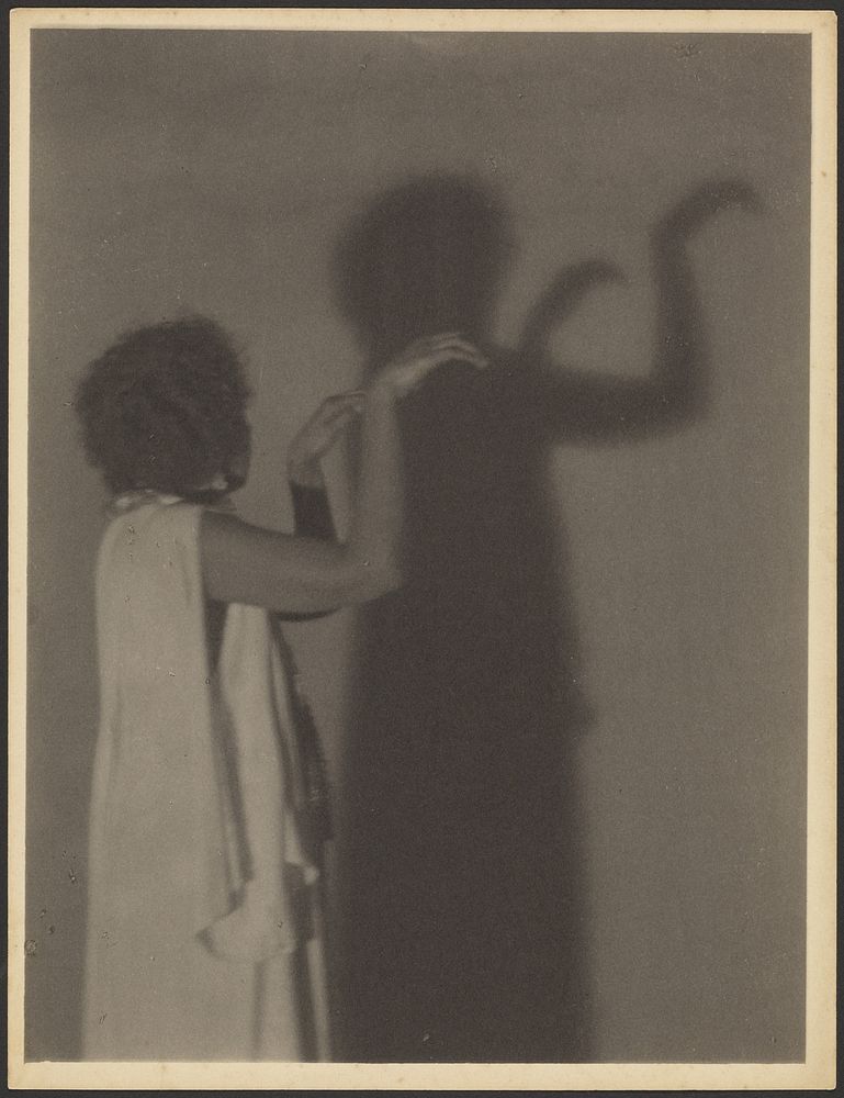 Woman Making Hand Shadows on Wall by Doris Ulmann