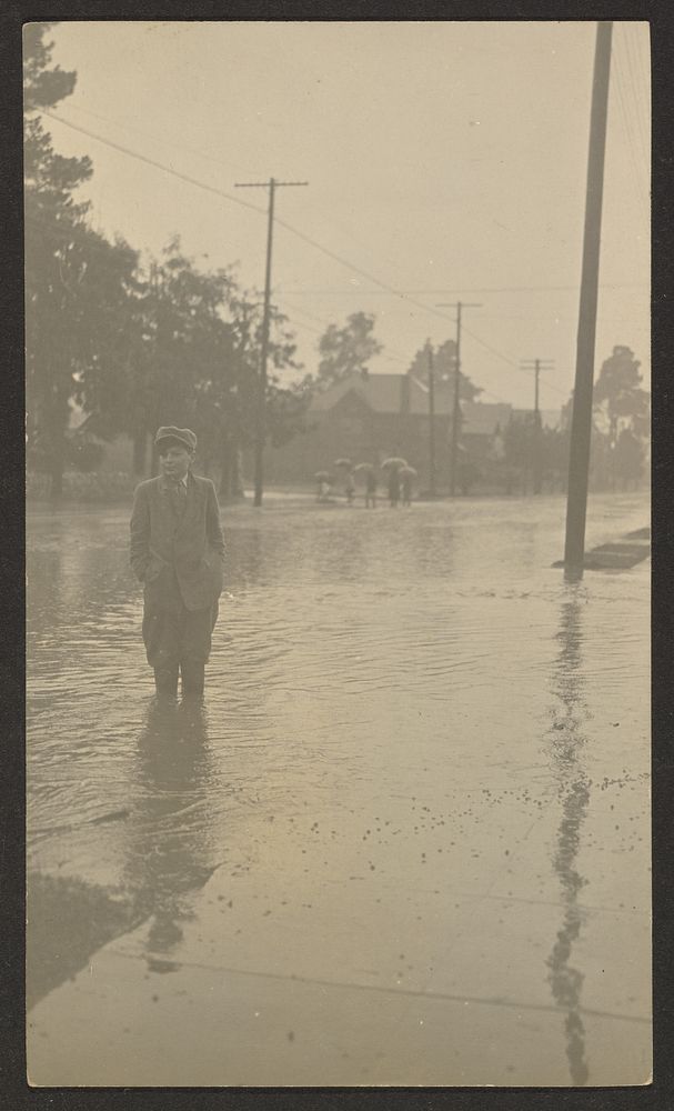 Boy Standing in Flooded Street by Louis Fleckenstein