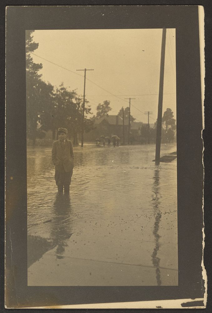 Boy Standing in Flooded Street by Louis Fleckenstein