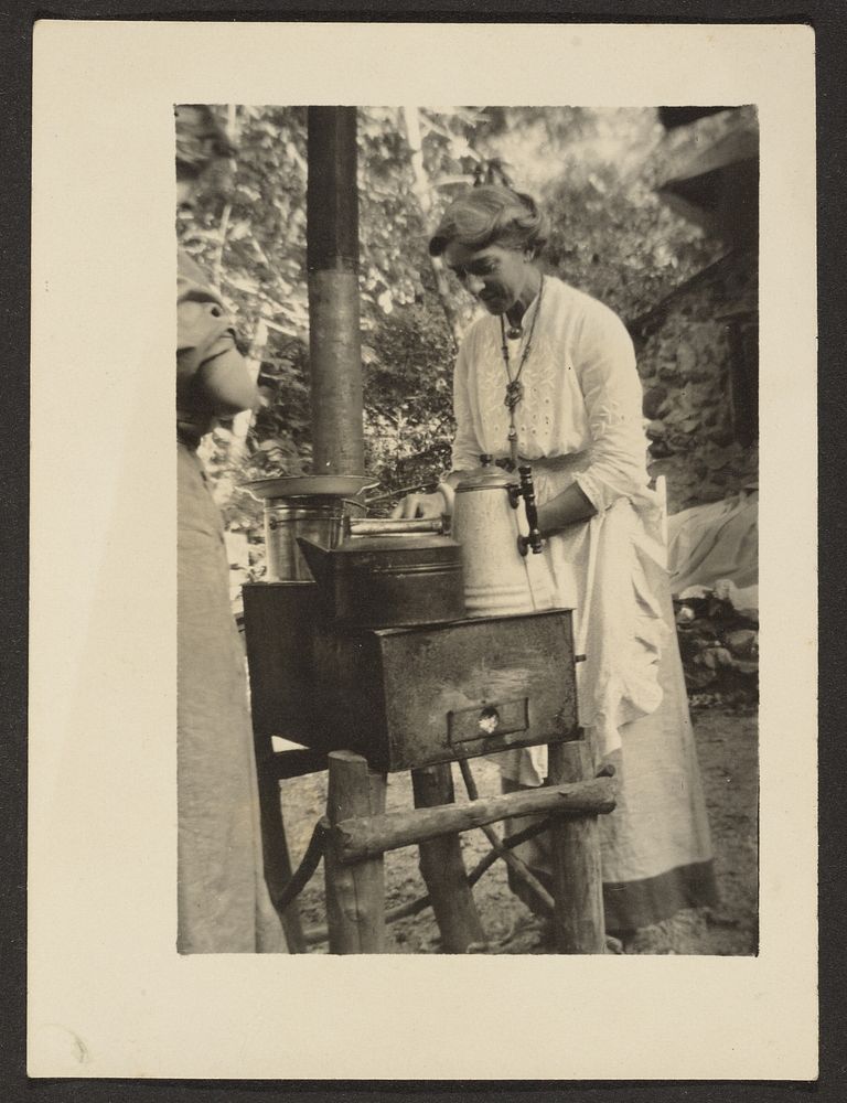 Woman Using Outdoor Stove by Louis Fleckenstein